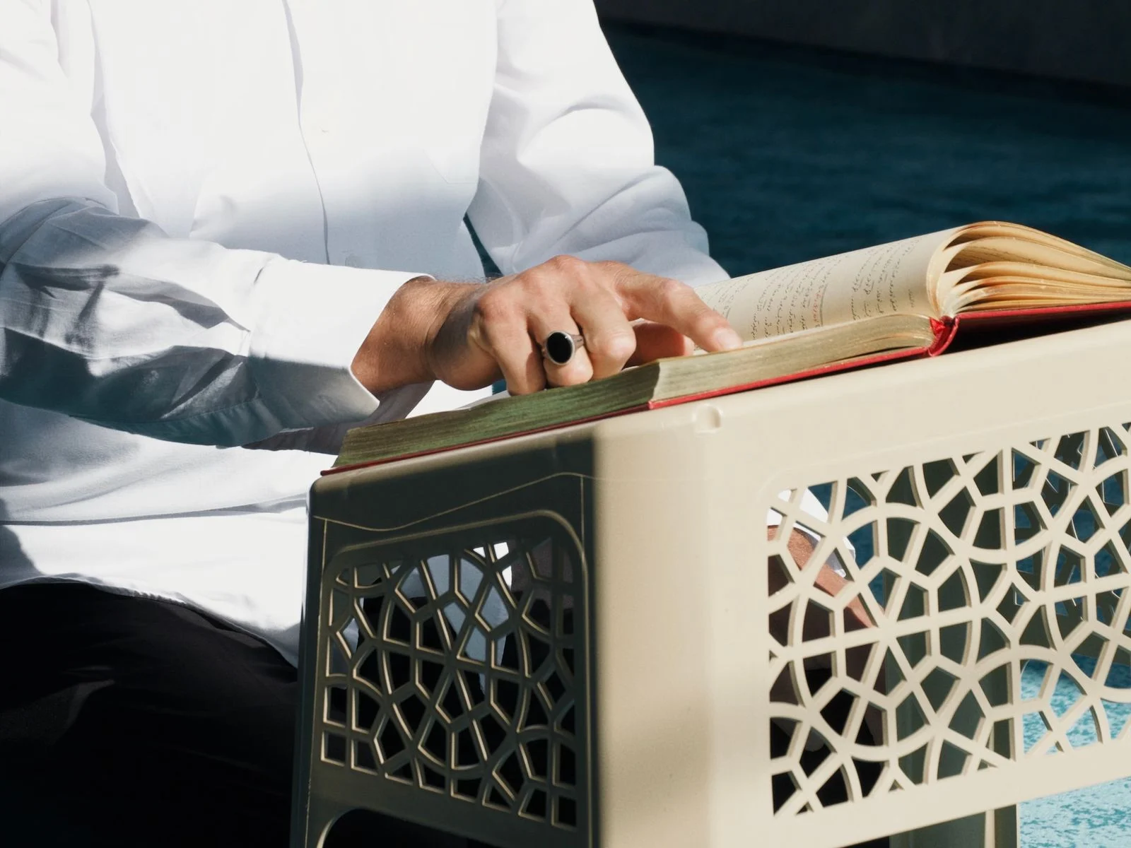 Adult man reciting the Quran with confidence in a mosque