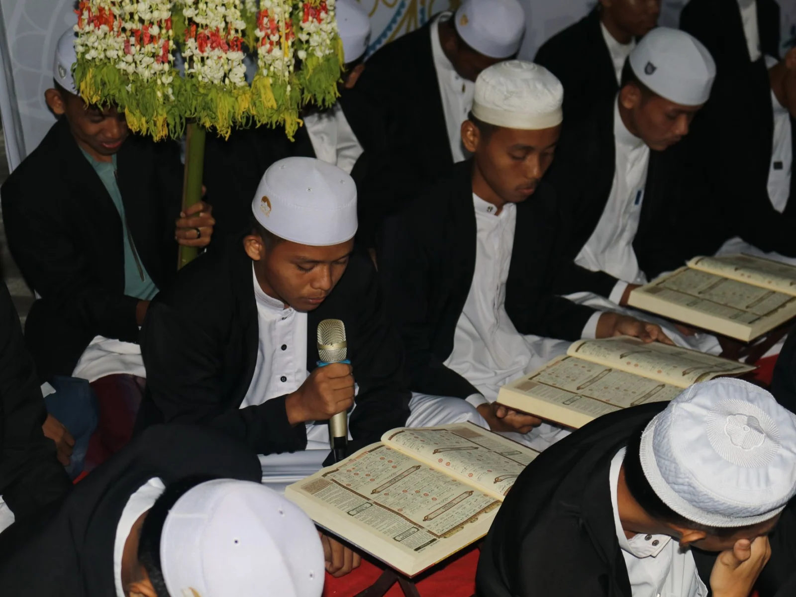 Hifz students in kufis reciting and memorizing the Quran together