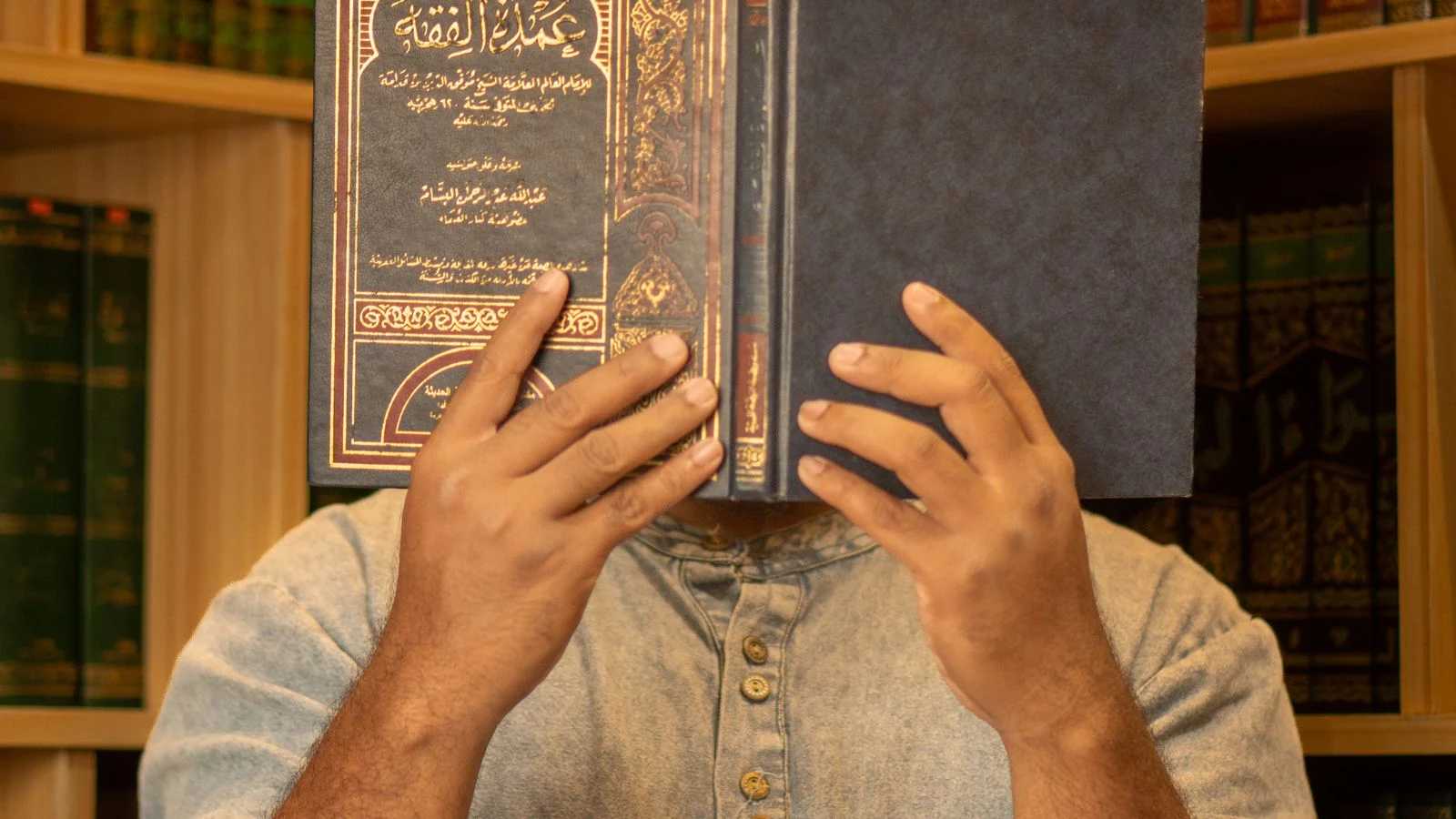 Learner reading a classical Arabic book to study grammar