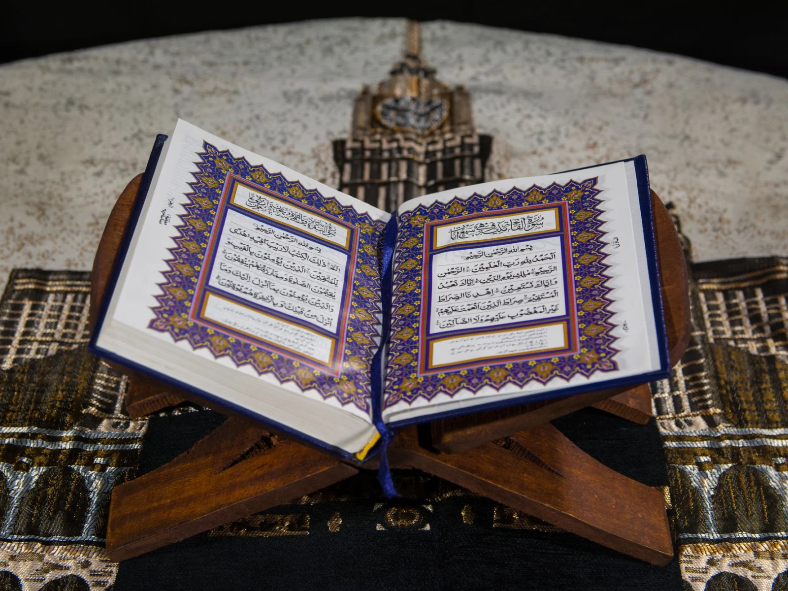 Open Quran on a wooden rehal with both opening pages fully visible