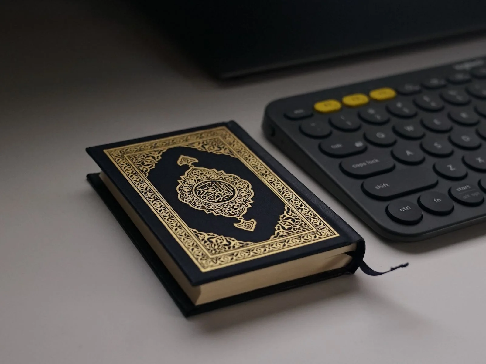 Quran beside a keyboard for online Tajweed classes